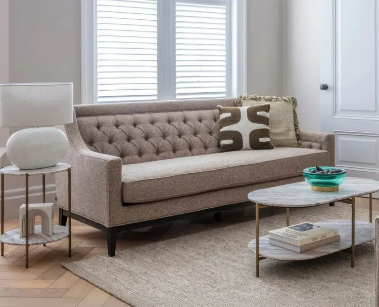 Living room with a tufted sofa and marble coffee table